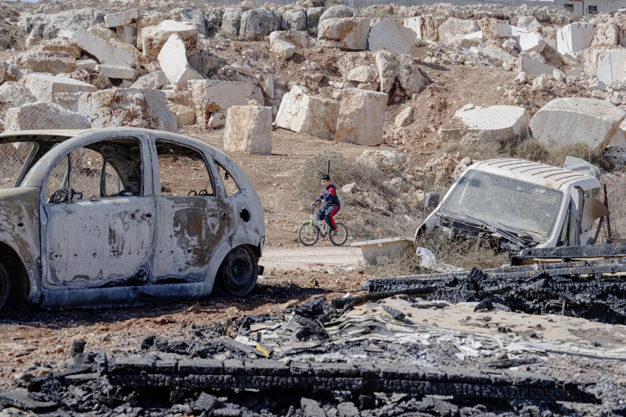 Tanya Habjouqa/NOOR for NPR

Qusra, Occupied Palestinian Territory 


Home of initial site of settler attack. Palestinians were running to protect their home, and one of their cars was torched. (the one in front, the car in back is old and in decay). A neighboring child drove his bicycle past. 

Sisters, wives, mothers, cousins and community  gather and mourn at the Qusra wake for for four of the six men killed in Qusra. (a separate wake was under way for other two)

Since the beginning of the week, there have been dozens of violent incidents by settlers against Palestinians across the West Bank. In the most severe incident in the village of Qusra (South of Nablus), four Palestinians were killed, and nine were injured after settlers entered the village and opened fire. Soldiers of the IDF were also present at the incident, and it is still not clear whether the deaths were caused by settler fire or by the IDF. The day after the incident, during the funeral of the victims, settlers called on people to come and stop the funeral procession. Indeed, the funeral procession was attacked on its way to Qusra and a Palestinian father and son were killed. 


The Qusra mayor,Hani Abu Ala, gave us a tour of there house that had been under attack when the initial attack occurred, and showed us proximity of the settlements encroachment on their village. 


We attended a wake of four of those killed, young men named Muaz Abed Odeh, Hassan Muhaned Odeh, Musab abdelhalim Abu Reida, Obeidah sa’ed Abu Saroor.

Ahmed Wadi, 26, and his father Ibrahim, 63, were both killed by Israeli settlers at a funeral procession for four other Palestinians in Qusra village in the West Bank, the Palestinian Ministry of Health said this week.