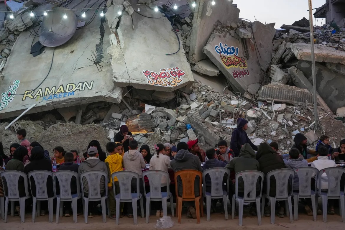 A mural reading "Ramadan brings us together" with a crescent moon was painted onto one of the walls left standing. [Abdel Kareem Hana/AP Photo]