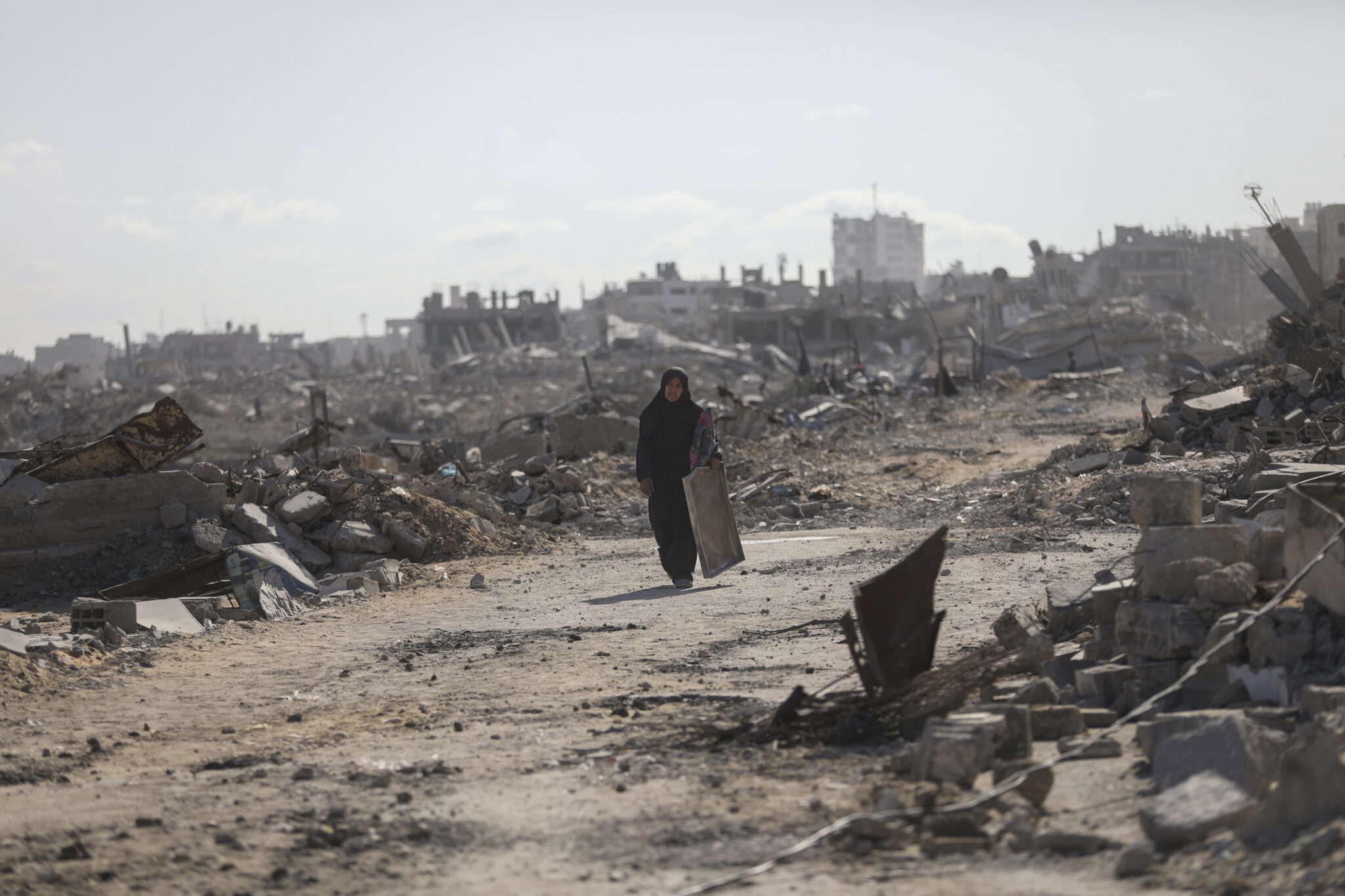 Palestinians return to their homes, Gaza city, 11.10.2025 A Palestinian woman walks amid ruins as Palestinian families return to what remains of their homes in the Sheikh Radwan area of the devastated Gaza City, October 11, 2025, Yousef Zaanoun