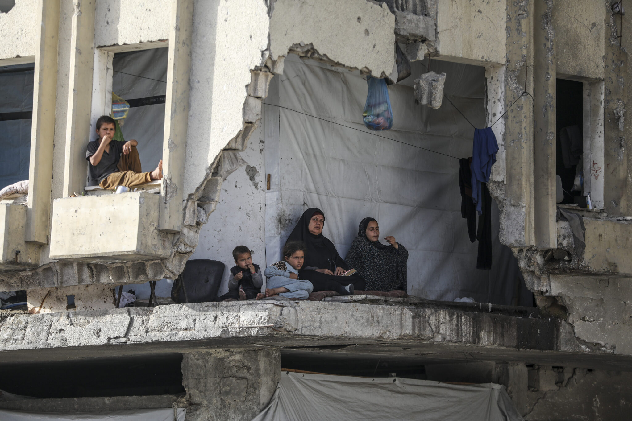 A displaced family living in a heavily damaged building west of Gaza City, 12 May 2026. Photo: Yousef Zaanoun