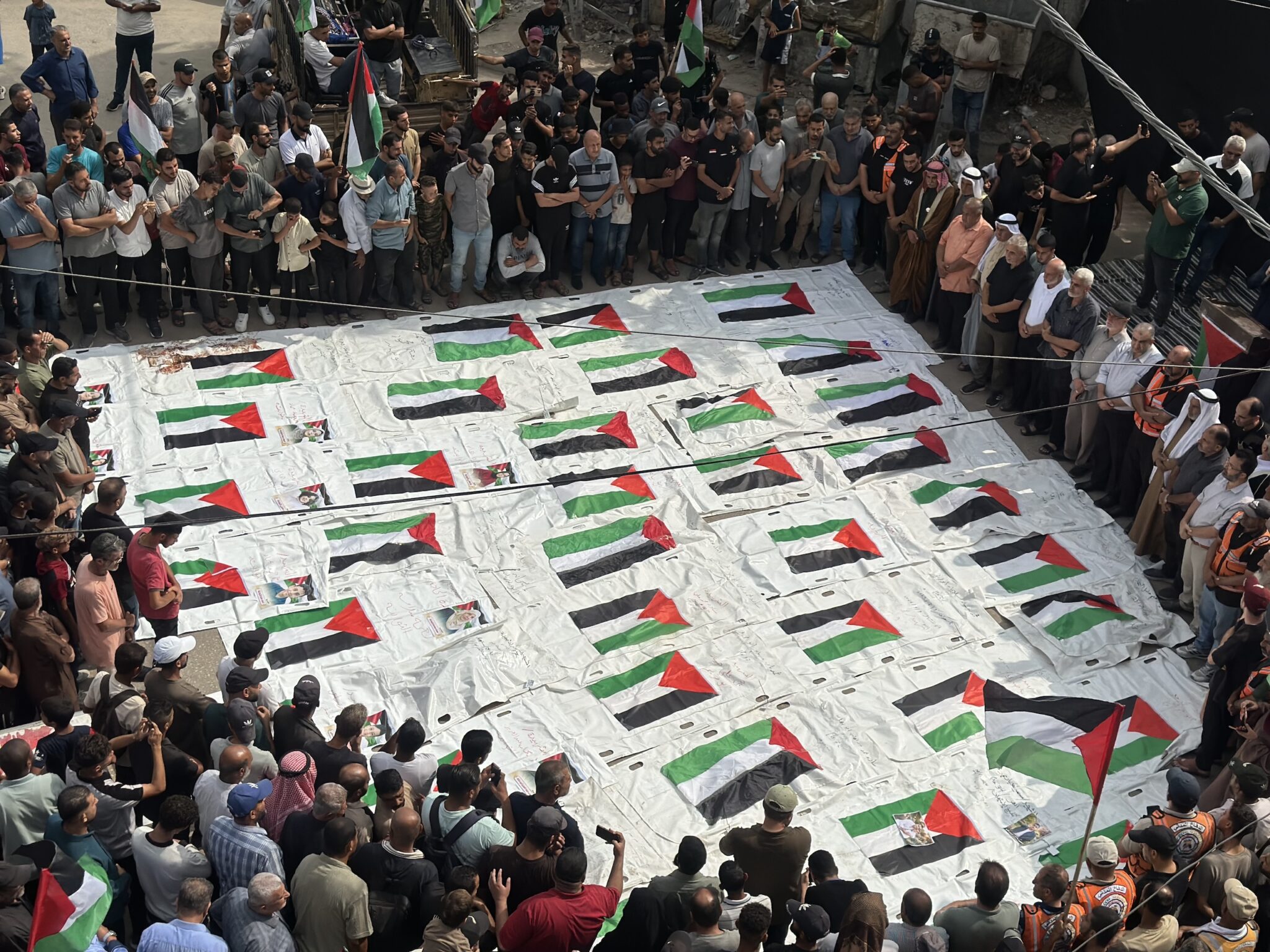 main_image69113_bZ8qETgnAD Palestinians gather in Nuseirat refugee camp, central Gaza Strip, to mourn 43 people whose remains were recovered from the rubble by a Civil Defense team, 29 September 2026.