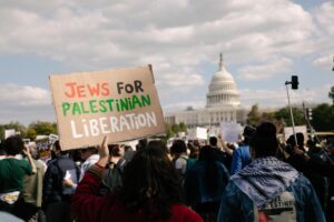 A person holds a sign reading "Jews for Palestinian Liberation"